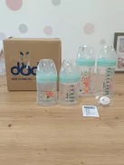 DODIE 4 db cumisüveg újszülötteknek, kerek anti-kólikás etetőcumival (2 x 150 ml és 2 x 270 ml) + 1 cumi újszülötteknek OUTLET termék